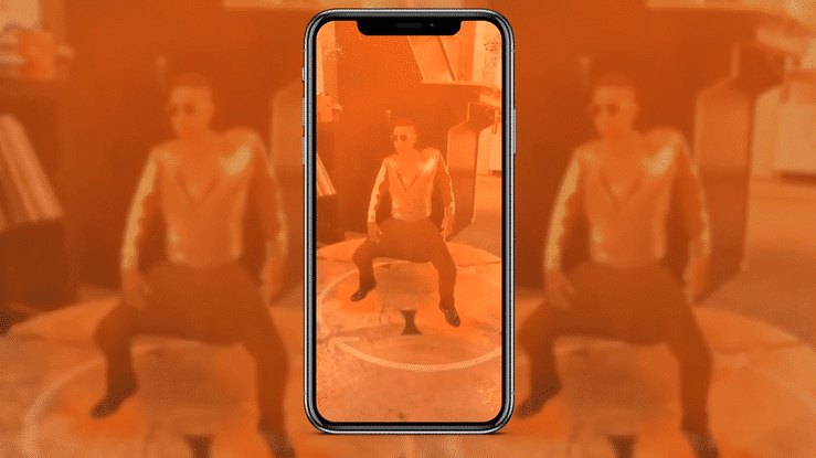 The lens running live, a mini MC Hammer dancing on a table seen through the phone
